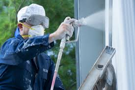 painter using paint sprayer