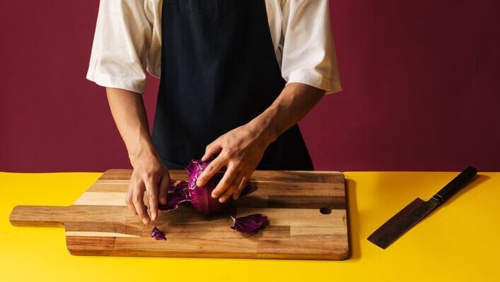 a man cutting cabbage